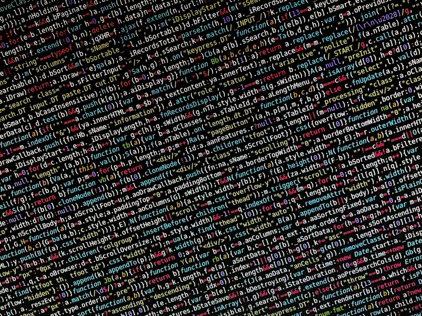 In the image, a densely packed screen displays lines of computer code with syntax highlighting and multicolored text, including keywords, functions, and variables in various shades of red, blue, yello